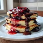 blueberry pancakes with chocolate ganache and berry sauce