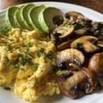 keto breakfast plate with creamy scrambled eggs mushrooms avocado