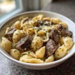 steak bites and shell pasta in garlic butter alfredo sauce
